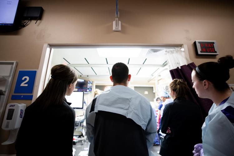 A team of trauma providers watch a case in the Level I Trauma Center at JPS Health Network in Fort Worth Texas.