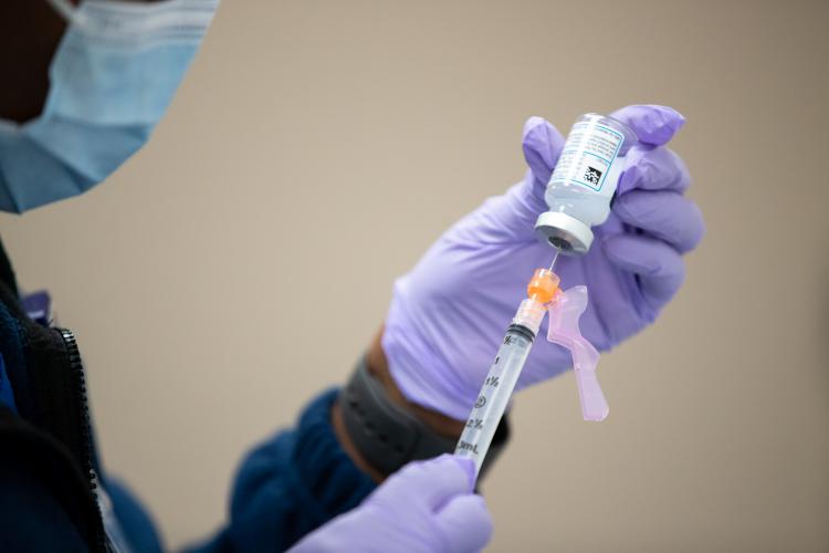 A nurse at JPS Health Network prepares to give a COVID-19 vaccination.