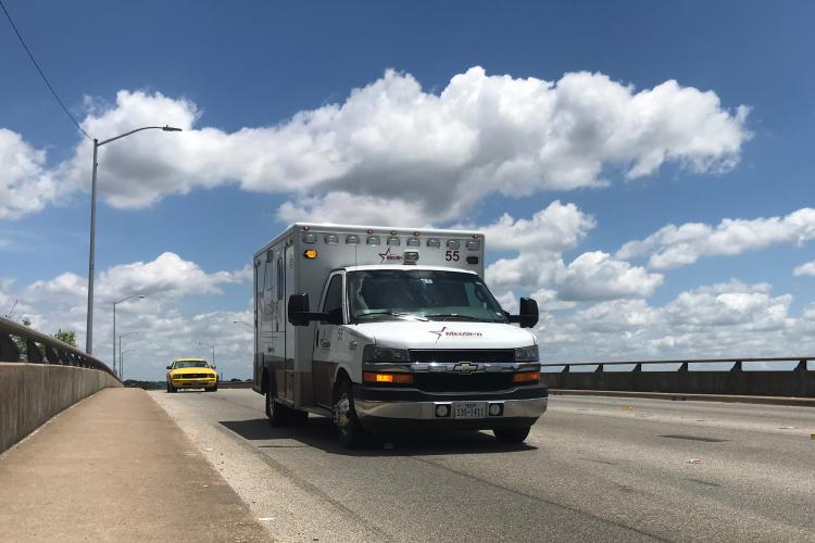 An ambulance crosses the Allen Avenue bridge near JPS.