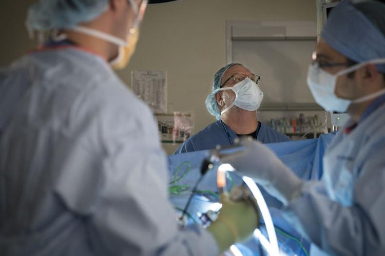 David Olson, CRNA, watches over a patient in an operating room at JPS
