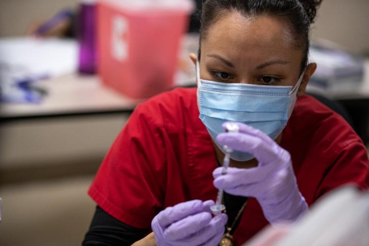 A COVID vaccination is given at JPS Health Network in Fort Worth, Texas