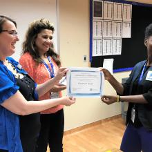 Volunteer Christina Lulenda receives a certificate of completion.