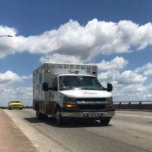 An ambulance crosses the Allen Avenue bridge near JPS.